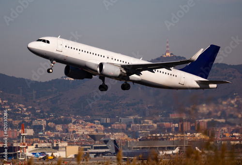 Image of passenger airplane take-off from airport at day