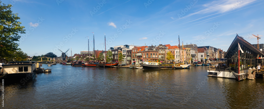 Fototapeta premium Quay with moored ships along Oude Rijn river in Leiden, Netherlands.
