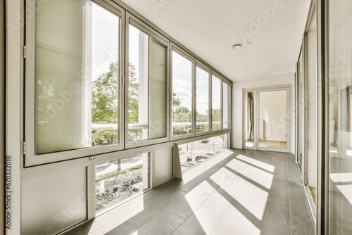 an empty room with large windows and floor to ceiling glass doors that look out onto the cityscapea