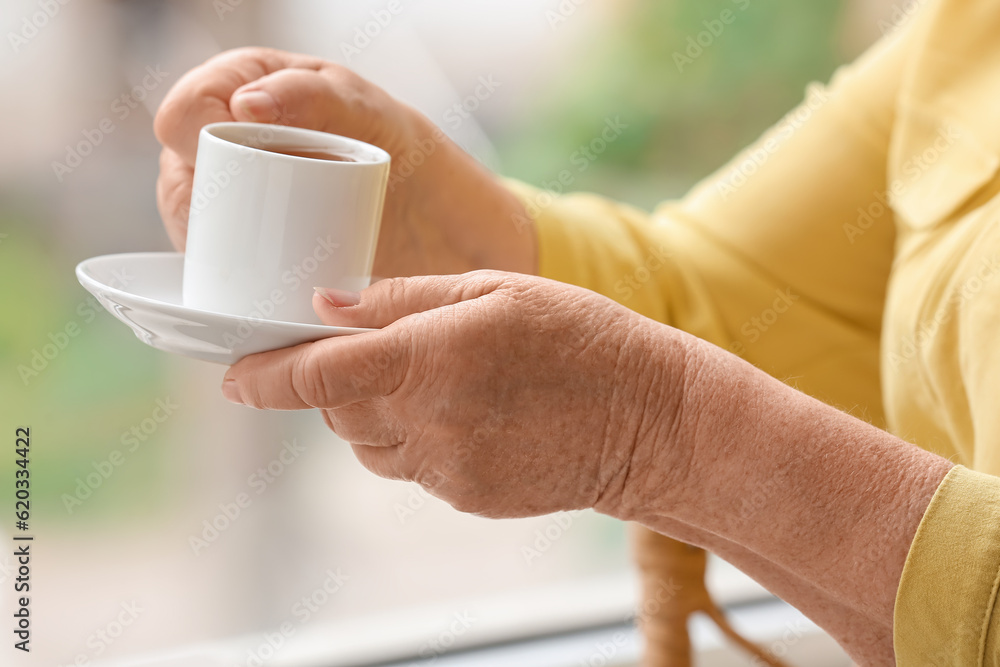 Senior woman with cup of coffee at home, closeup Senior woman with cup of coffee at home, closeup