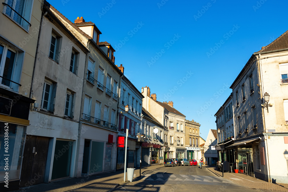 Street of Montmirail, Marne department, France. View of neat buildings with signboards.