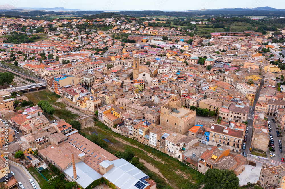Summer view from drone of center of medieval Spanish town of La Bisbal d Emporda with episcopal palace castle and Church of Santa Maria, province of Girona, Catalonia..