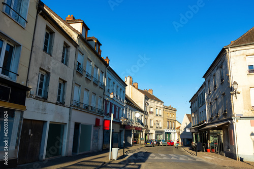 Street of Montmirail, Marne department, France. View of neat buildings with signboards. © JackF
