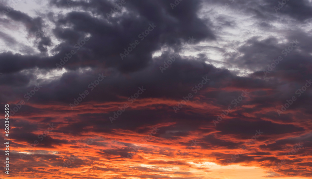 Real amazing sunrise or sunset sky with gentle colorful clouds