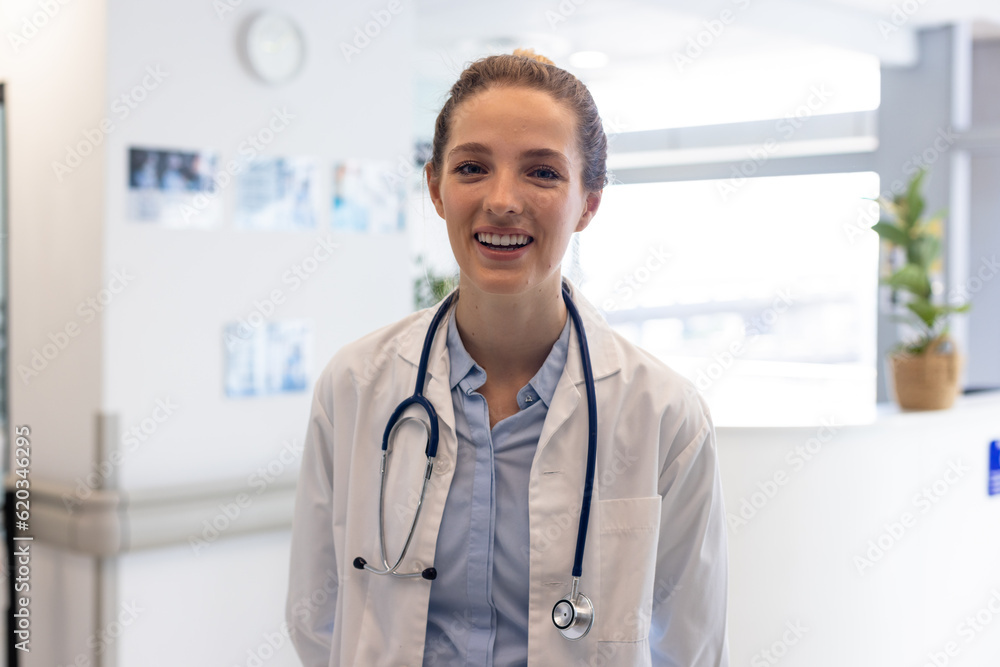 Portrait of happy caucasian female doctor wearing medical uniform and stethoscope at hospital