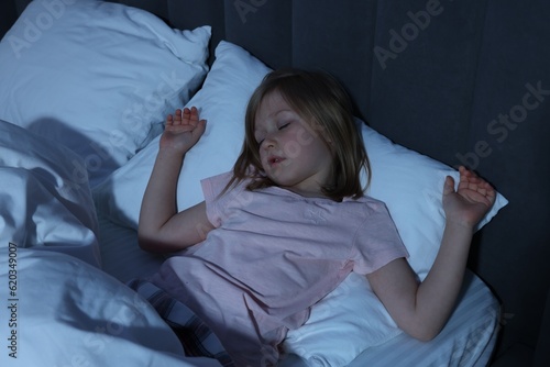 Little girl snoring while sleeping in bed at home