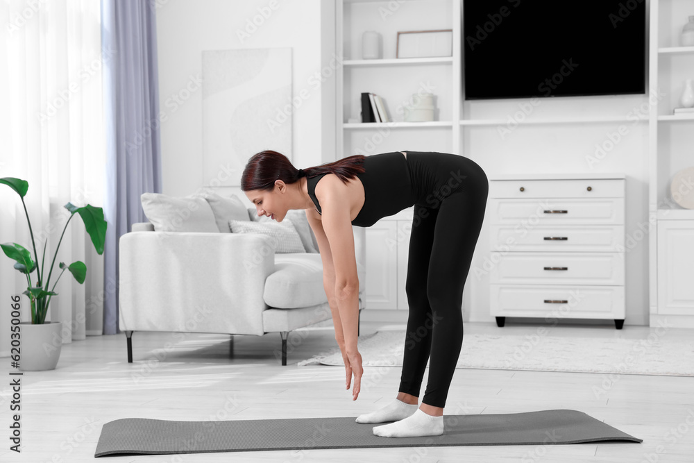 Morning routine. Woman doing stretching exercise at home Morning routine. Woman doing stretching exercise at home