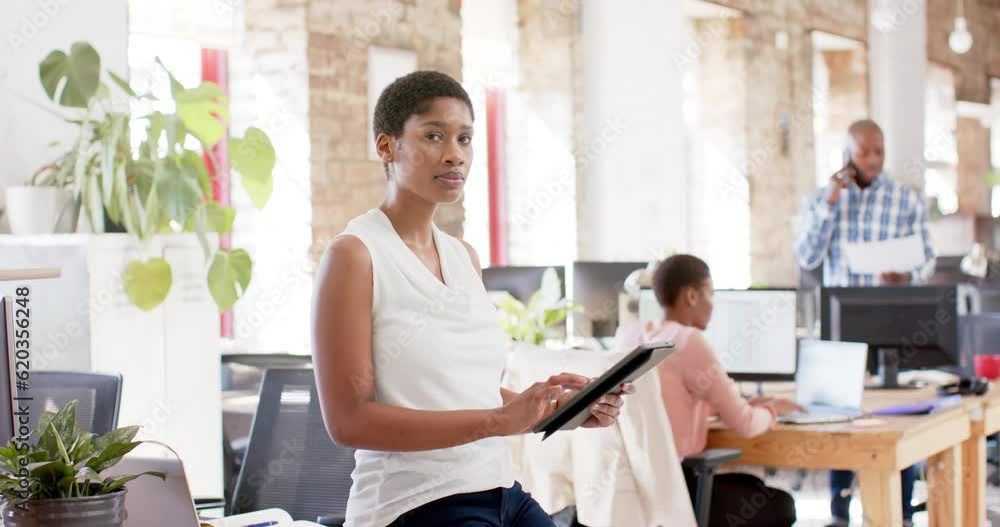 Portrait of happy african american colleagues with tablet in creative office in slow motion Portrait of happy african american colleagues with tablet in creative office in slow motion