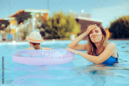 Stressed Mom Feeling Worried about Swimming Pool Safety. Tired mom parenting on summer vacation feeling concerned
 photo