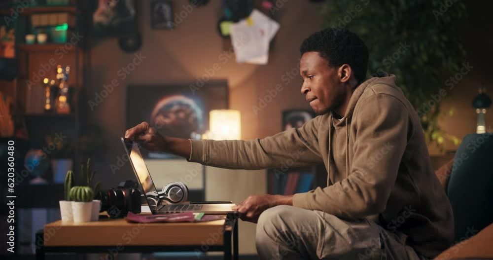 Music Producer man creating music using his computer and headphones. Music Producer man creating music using his computer and headphones.