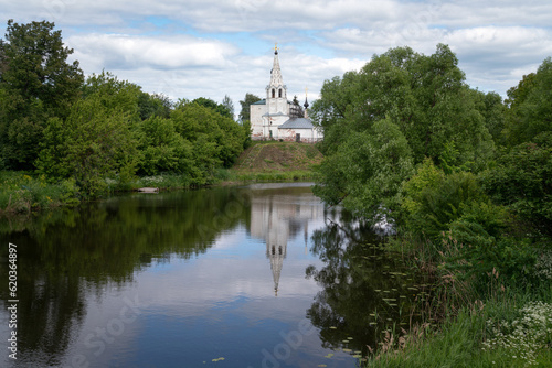View of the Church of Cosmas and Damian on Yarunova Hill (Kozmodemyanskaya Church) on the bank of the Kamenka River on a sunny summer day, Suzdal, Vladimir region, Russia