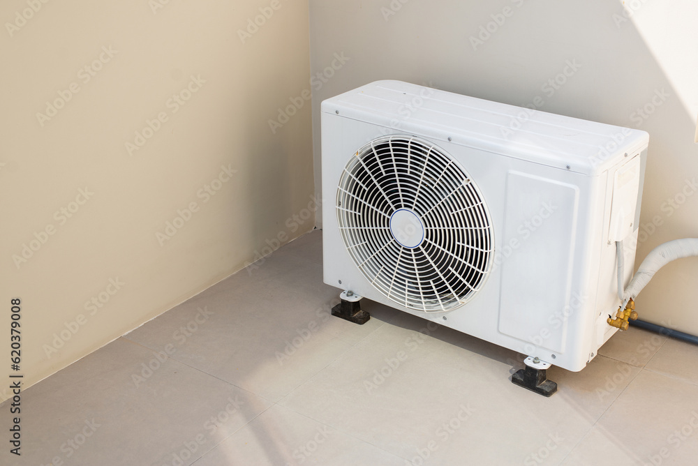 Installed outside the house's wall is a compressor for the outside air conditioner.