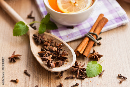 close up of anise star tea and cinnamon stick on wooden table