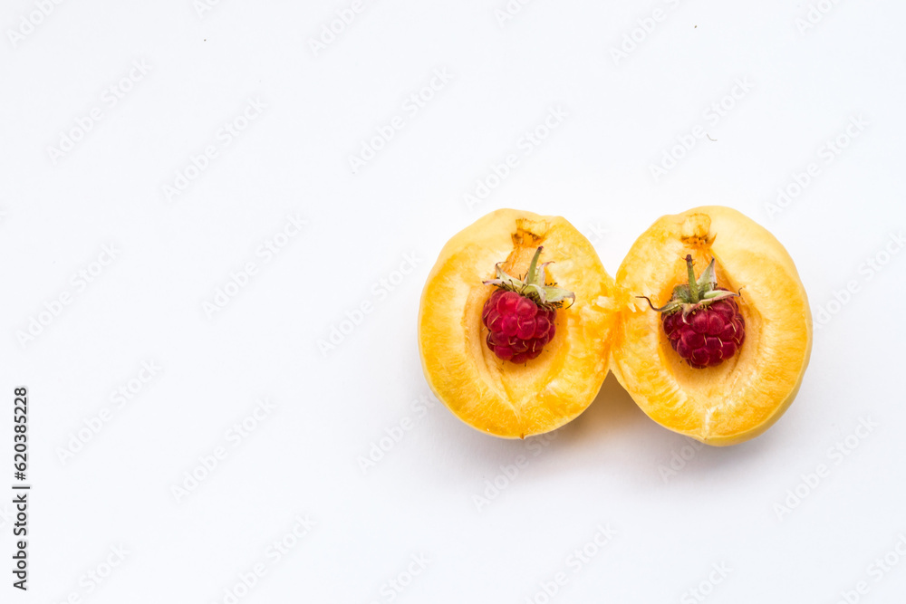 Photo of the two raspberries in part apricot, copy space