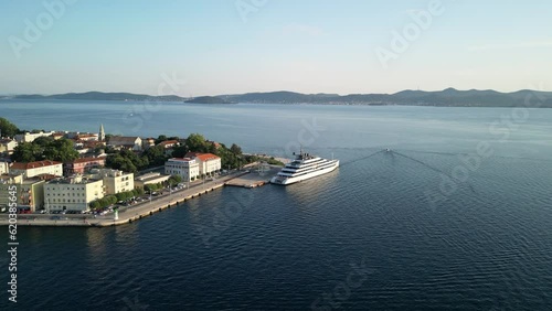 Drone lift up over blue Adriatic while cruise ship is docked at old town Zadar in Croatia photo