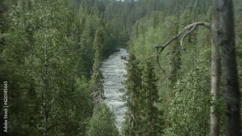 Beautiful Wide shot of a People River Rafting in the Finish Forest, Karhunkierros, Oulanka, Rukka, Aallokkokoski photo