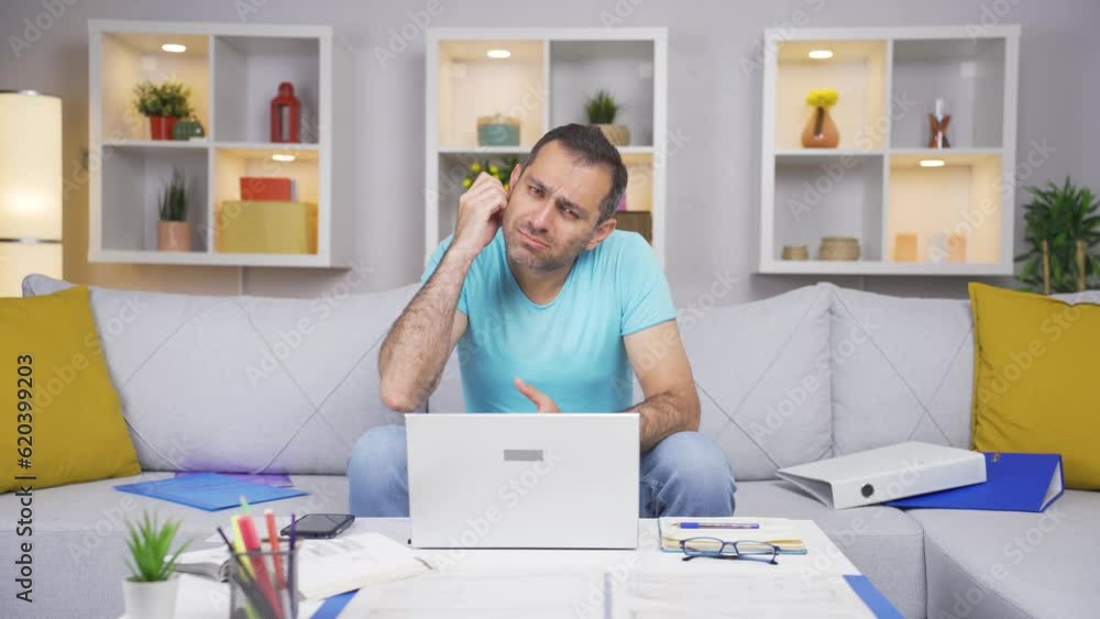 Home office worker man scratches his ears looking at camera. Home office worker man scratches his ears looking at camera.