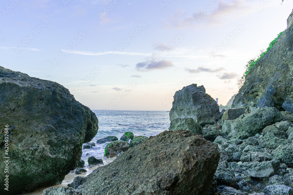 View of beautiful coral rocks by the ocean under a beautiful blue sky horizon