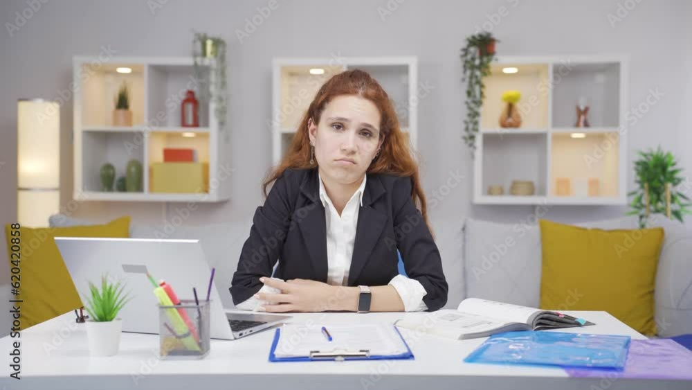 Home office worker woman looking annoyed at camera. Home office worker woman looking annoyed at camera.