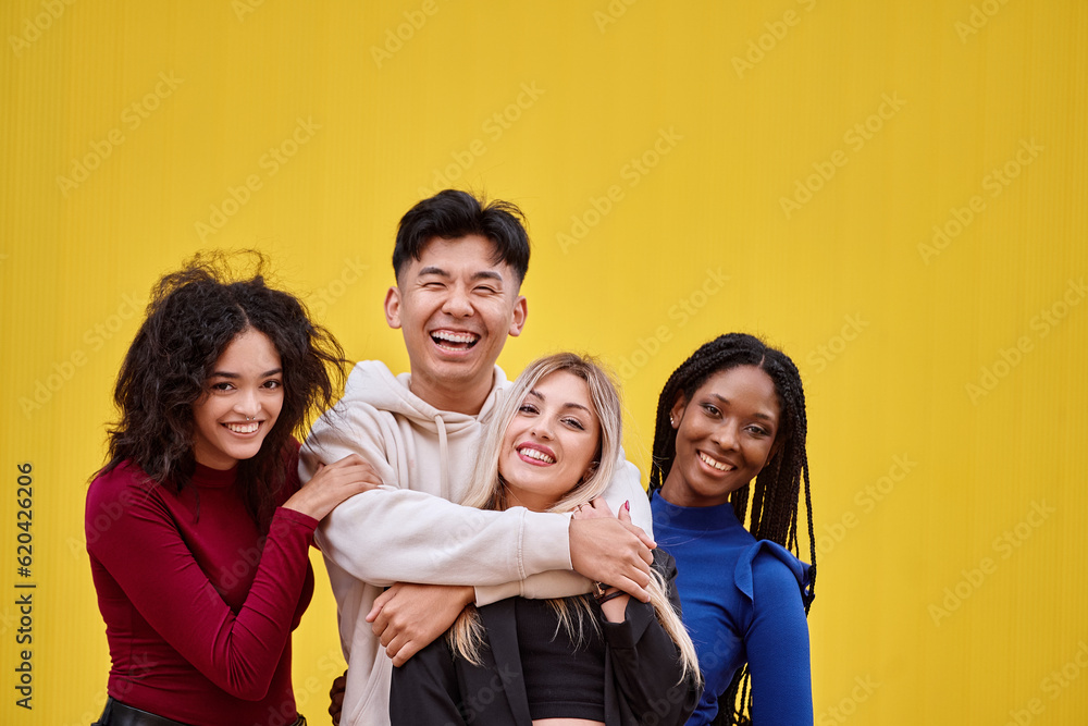 Multi-ethnic friends looking at camera and smiling while posing together. Friendship concept.