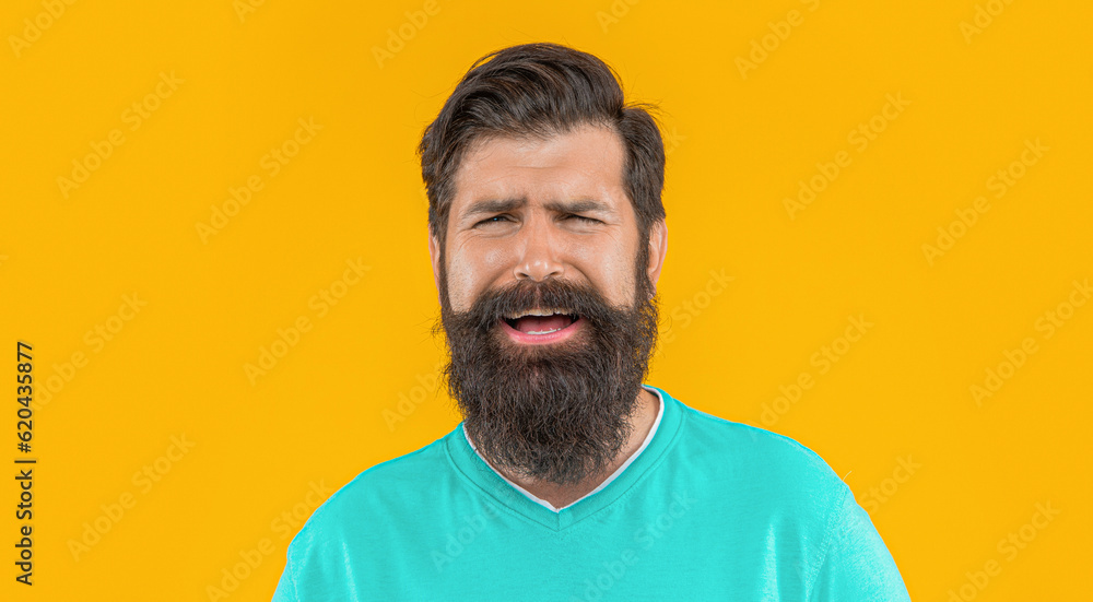 Obraz premium portrait of sad bearded guy isolated on yellow. portrait of bearded guy in studio.