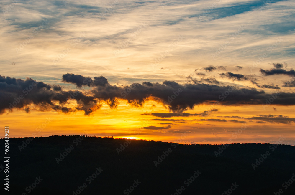 A beautiful orange sunset with a silhouette of the mountains