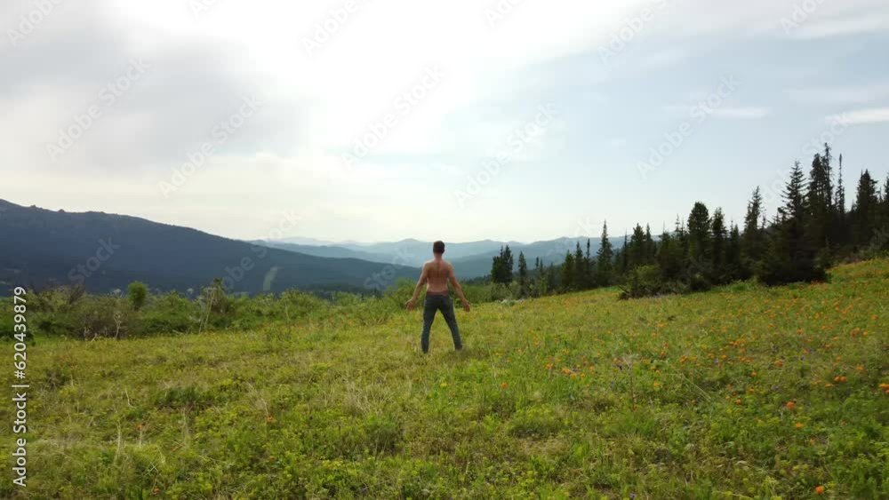 Man doing yoga outdoors, at mountains background. Man doing yoga outdoors, at mountains background.
