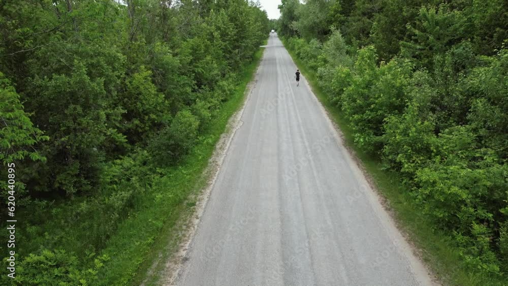 Aerial View Of A Person Running Alone At The Countryside Road. Aerial View Of A Person Running Alone At The Countryside Road.