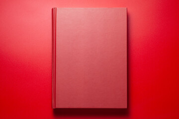 A red book on red background, Top view.