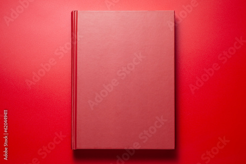 A red book on red background, Top view.