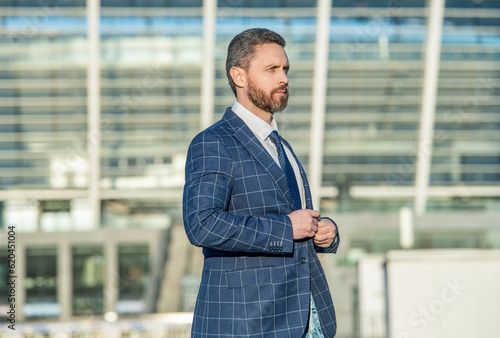 caucasian business executive on urban background. business executive wearing jacket