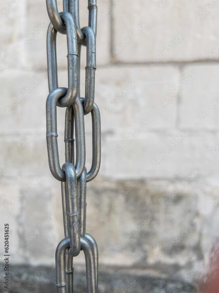 Large strong metallic chain in vertical position Large strong metallic chain in vertical position