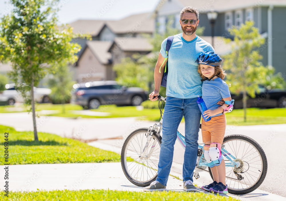 Obraz premium father teaching his son to ride a bicycle, copy space. father and son outdoor. father and son enjoying a bicycle ride together. active son and father duo cycling through scenic countryside on bicycle