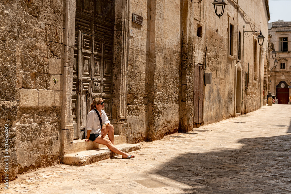 Tourist sitting in old town of Monopoly - Italy 