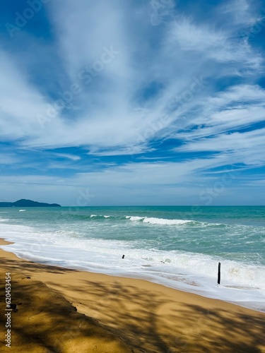 Sandy beach and sea with natural sky background