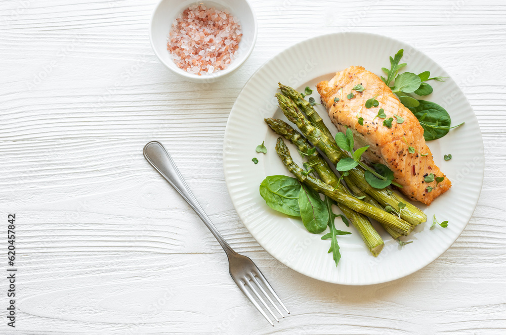 Baked Delicious salmon, green asparagus on  plate