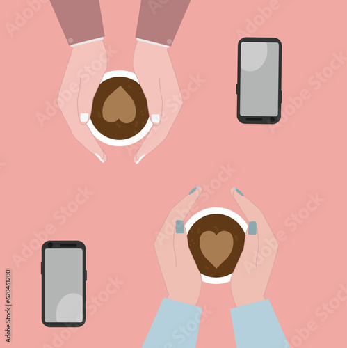 A couple in love sitting at a table in a cafe and holding cup of coffee.