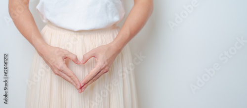 Bilde på lerret Woman hand heart shape over abdomen