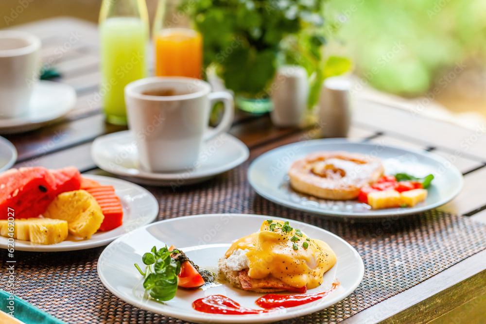 Healthy breakfast with delicious tropical fruits, eggs and freshly brewed coffee served on a table in a Thai resort. Healthy breakfast with delicious tropical fruits, eggs and freshly brewed coffee served on a table in a Thai resort.