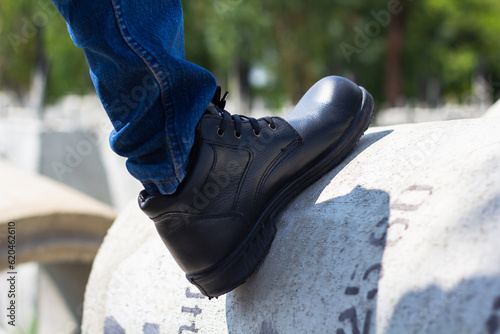 Wear safety shoes to ensure safety at work. construction workers wear safety shoes. People with factory safety concept photo