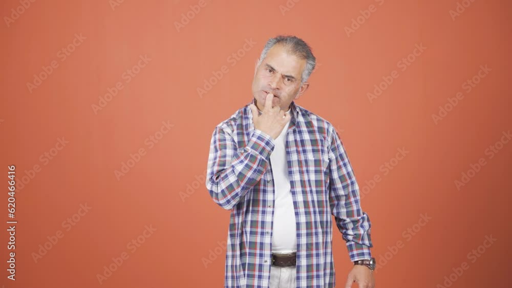 The man is biting his nails. The man is biting his nails.