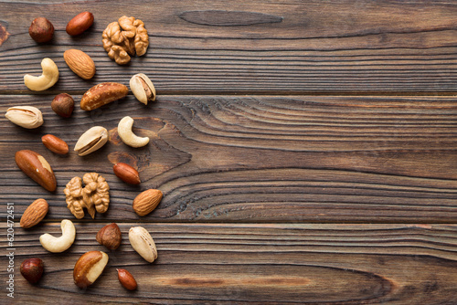 Composition of nuts , flat lay - mix hazelnuts, cashews, almonds on table background. healthy eating concepts and food background