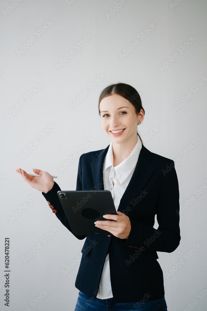 Smiling caucasian young businesswoman bank employee worker manager boss ceo looking at camera, using tablet, laptop and notepad online isolated in white background. Smiling caucasian young businesswoman bank employee worker manager boss ceo looking at camera, using tablet, laptop and notepad online isolated in white background.