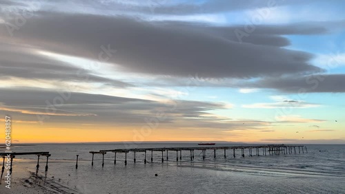 Morning calm chill sunrise view of the Magallanes Sea with the old pier in Punta Arenas, Chilean Patagonia photo