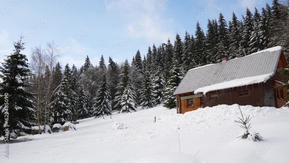 A cabin in a snowy rural area - view from below A cabin in a snowy rural area - view from below