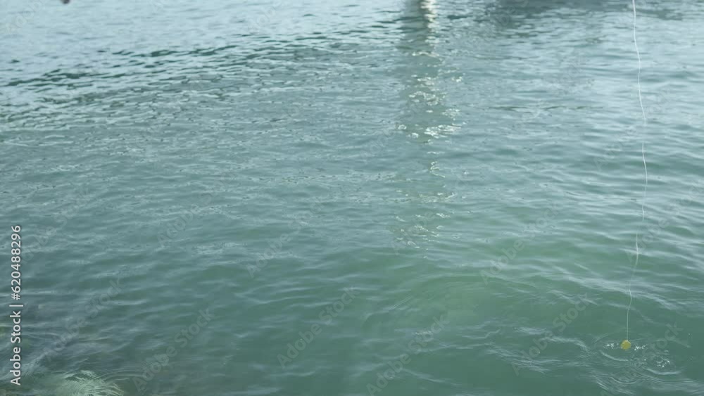 Caught a fish in on a yellow keychain. Fishing at sea. Slow motion type 2 Caught a fish in on a yellow keychain. Fishing at sea. Slow motion type 2