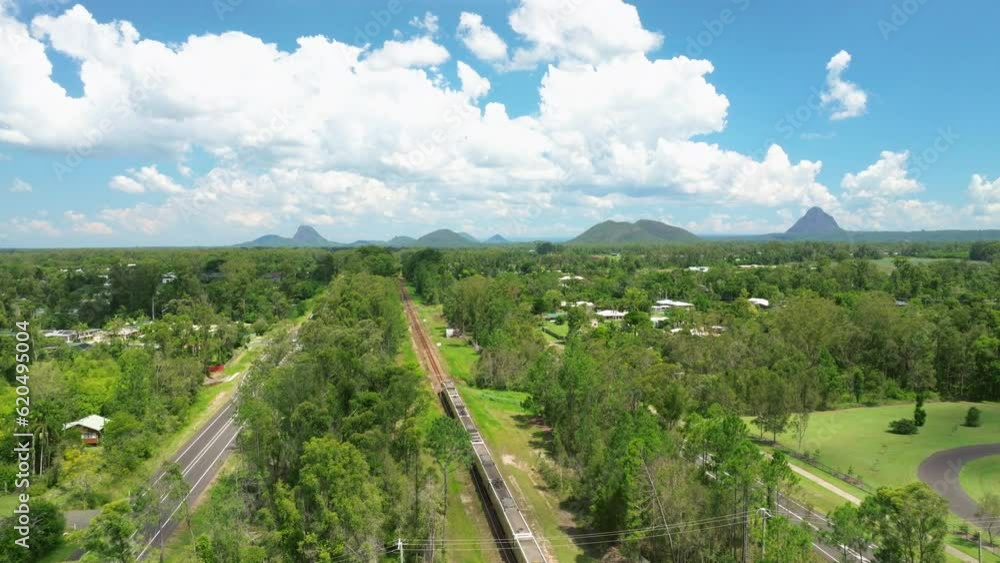 Queensland Train Railway Through Rural Countryside With Scenic Mountain Backdrop, 4K Drone View Queensland Train Railway Through Rural Countryside With Scenic Mountain Backdrop, 4K Drone View