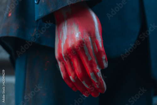 A bloody hand on a mannequin of a man in a suit. Halloween. © Denis Chubchenko