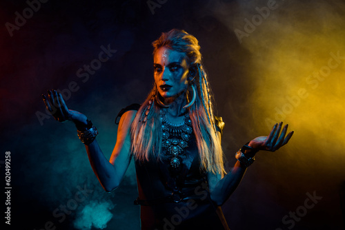 Portrait of mysterious enchant viking girl black magic ritual colorful lights fog isolated on black background