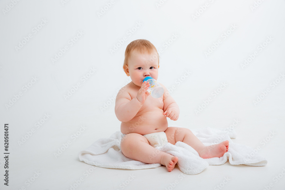 baby in a diaper sitting on a white background drinking from a bottle, high quality photos baby in a diaper sitting on a white background drinking from a bottle, high quality photos